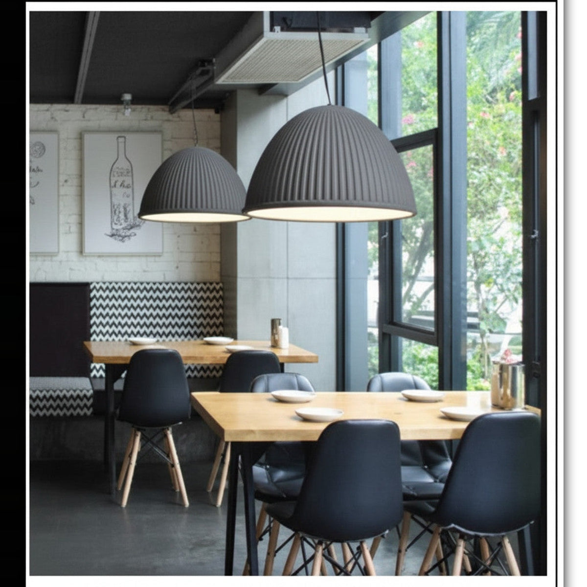 Lysverden grey ribbed dome pendant lights hanging over wooden dining tables in a modern restaurant interior