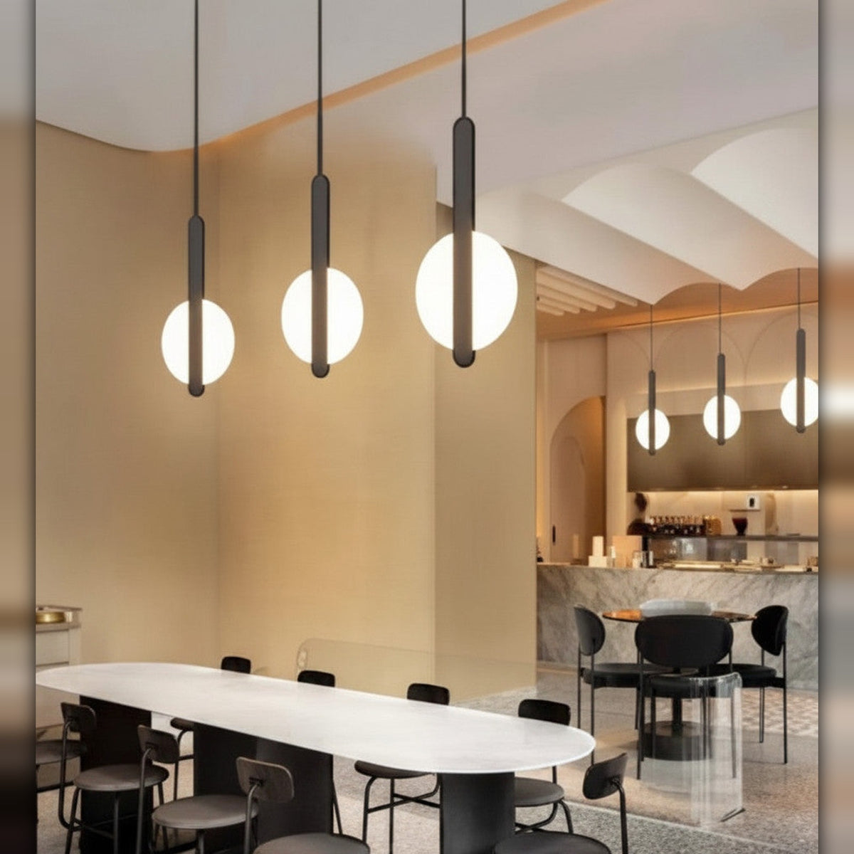 Lysverden minimalist LED pendant lights with glowing circular rings on black stems hanging over a modern dining table.