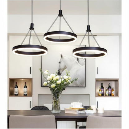 Lysverden modern black LED ring pendant lights hanging over a dining table, creating a minimalist Scandinavian look.