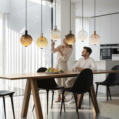 Lysverden AMBER pendant lamps with gradient glass shades hanging in a cluster over a modern dining table