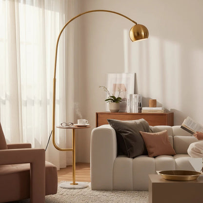 Lysverden arched floor lamp with a gold finish, marble base, and integrated side table in a modern living room