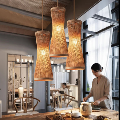 Lysverden handwoven bamboo pendant lights in a slender bottle shape hanging over a kitchen island in a Japandi home.