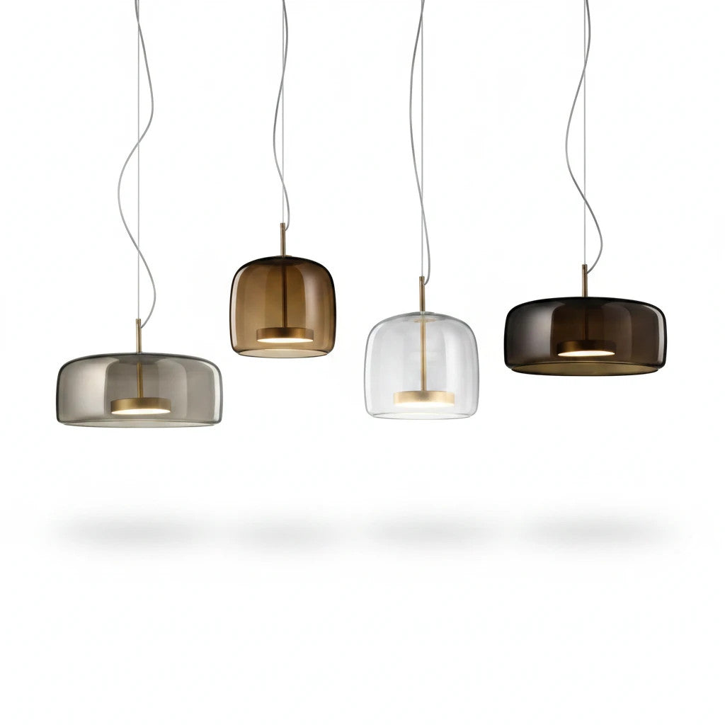 Lysverden bell-shaped pendant lamps in smoke, amber, and clear glass with metallic accents hanging in a row.