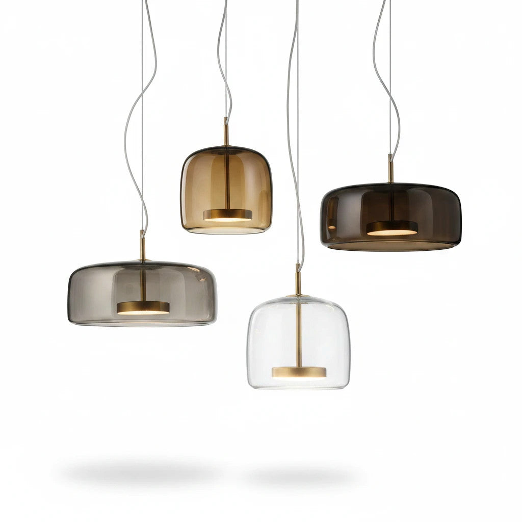 Lysverden bell-shaped pendant lights in smoke, amber, and clear glass with brass details hanging in a cluster