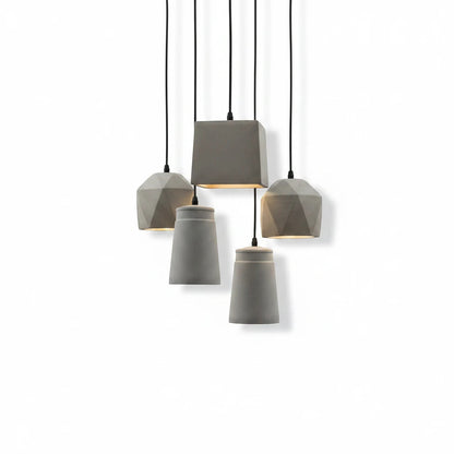 Lysverden BETONG industrial grey cement pendant lights with various geometric shapes hanging in a cluster