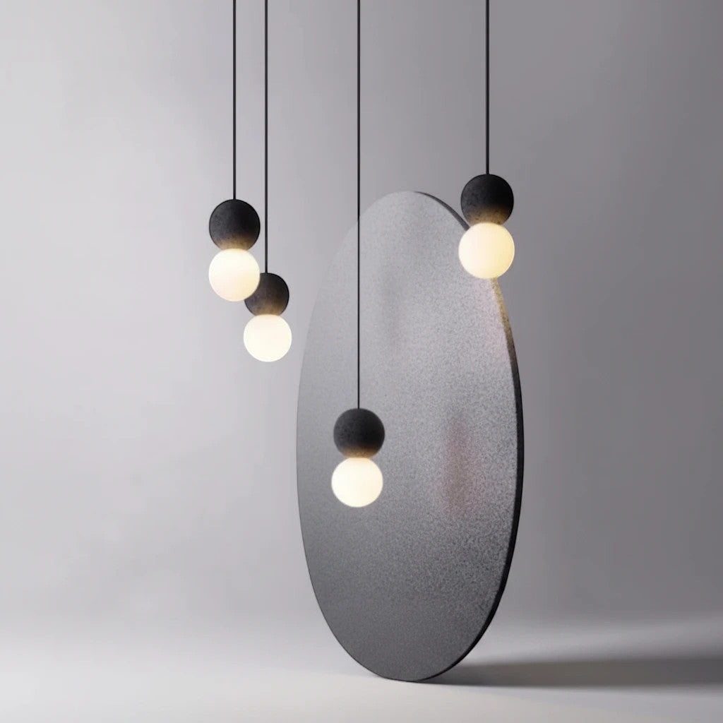 Lysverden Betongpendel minimalist pendant lights with matte concrete tops and glowing glass spheres in a cluster