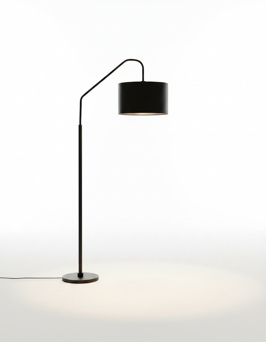 Lysverden black arched floor lamp with a fabric drum shade, providing soft ambient lighting for a living room.