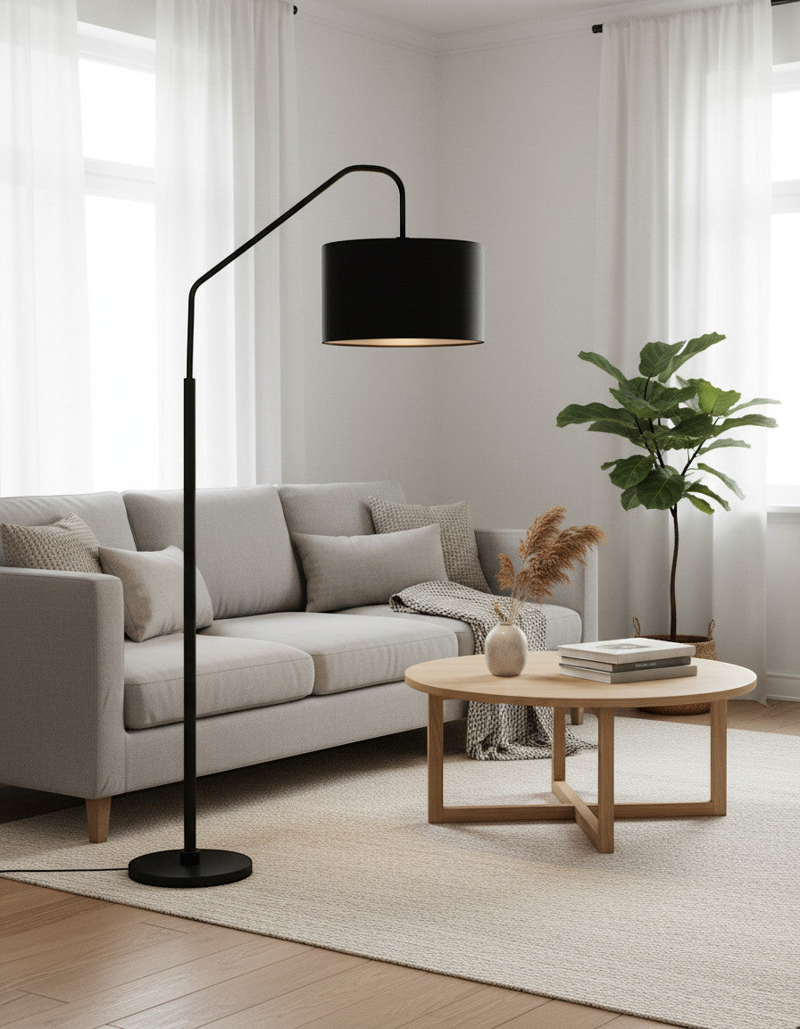 Lysverden black arched floor lamp with a fabric shade positioned over a grey sofa in a modern living room