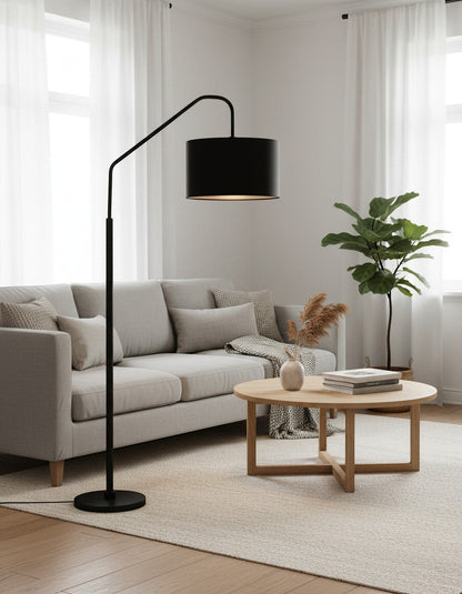 Lysverden black arched floor lamp with a fabric shade positioned over a grey sofa in a modern living room