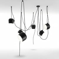 Lysverden black industrial drum pendant cluster with adjustable spotlights hanging at varying heights in a modern room