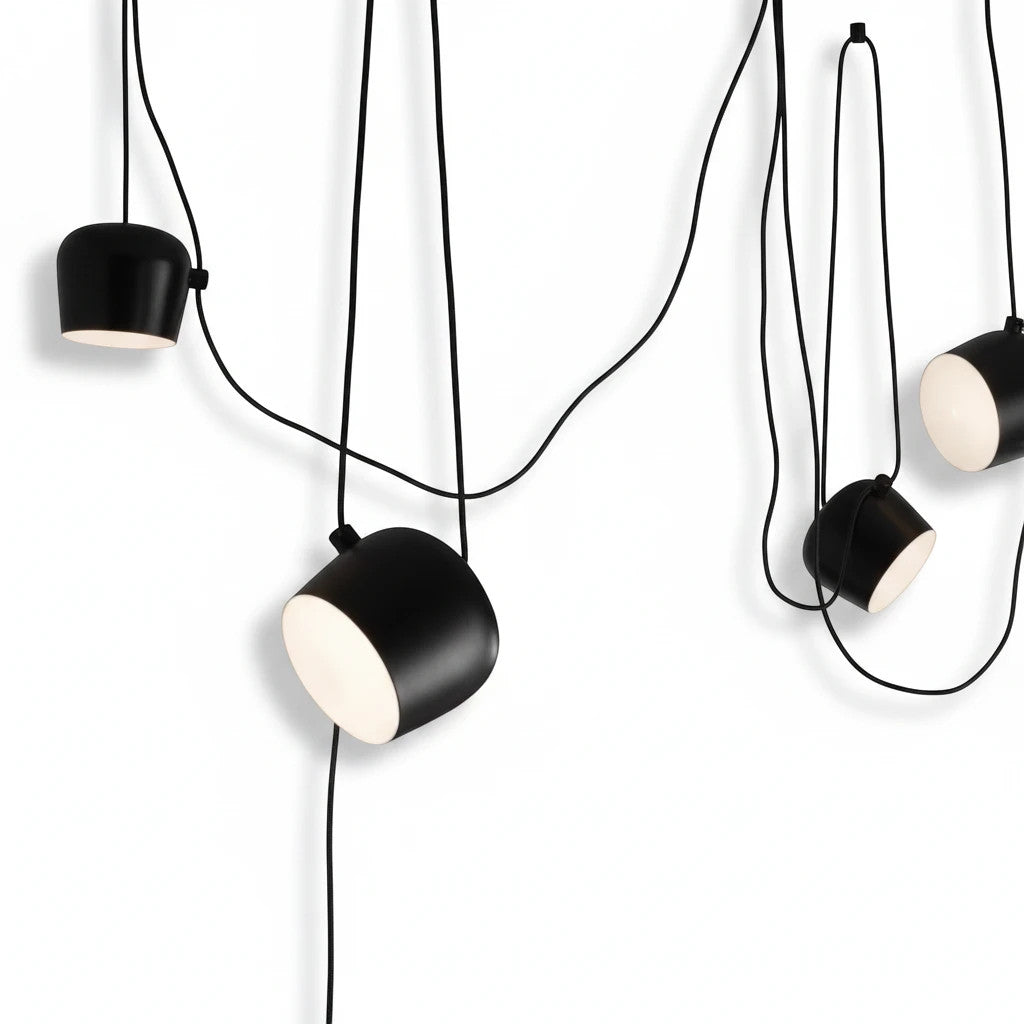 Lysverden black industrial drum pendant lights with adjustable heads and diffusers hanging in a cluster arrangement