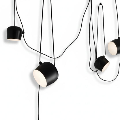Lysverden black industrial drum pendant lights with adjustable heads and diffusers hanging in a cluster arrangement
