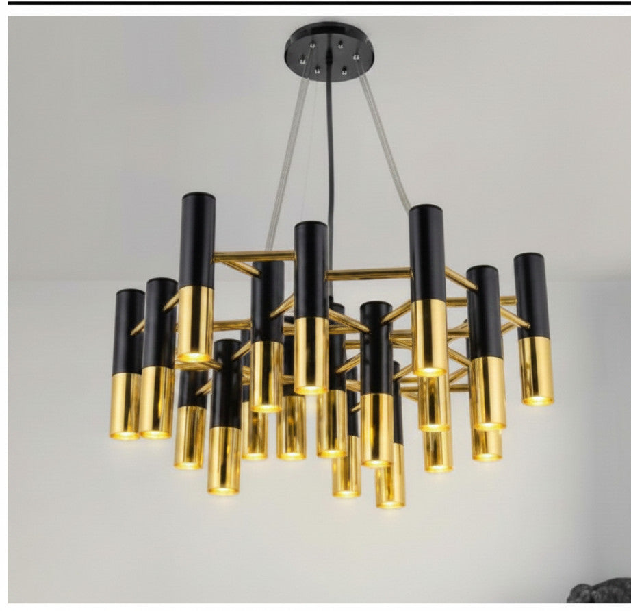 Lysverden art deco chandelier with vertical black and gold metal cylinder tubes providing focused downward lighting.