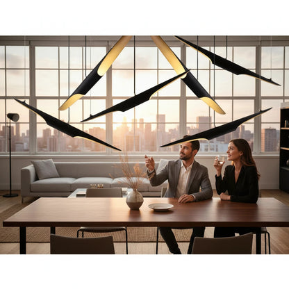 Lysverden sculptural pendant lights with black slanted tubes and gold interiors hanging over a modern dining table.