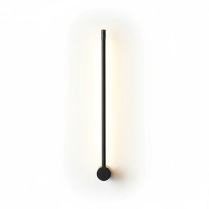 Lysverden minimalist black linear LED wall lamp casting a soft warm glow on a white wall