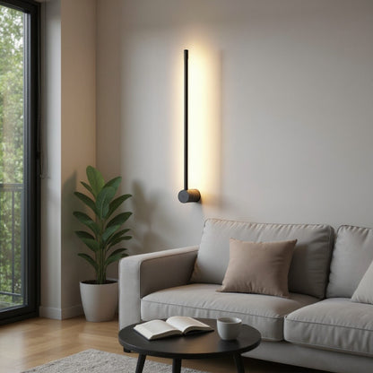 Lysverden modern black linear LED wall lamp casting a warm glow on a living room wall above a sofa