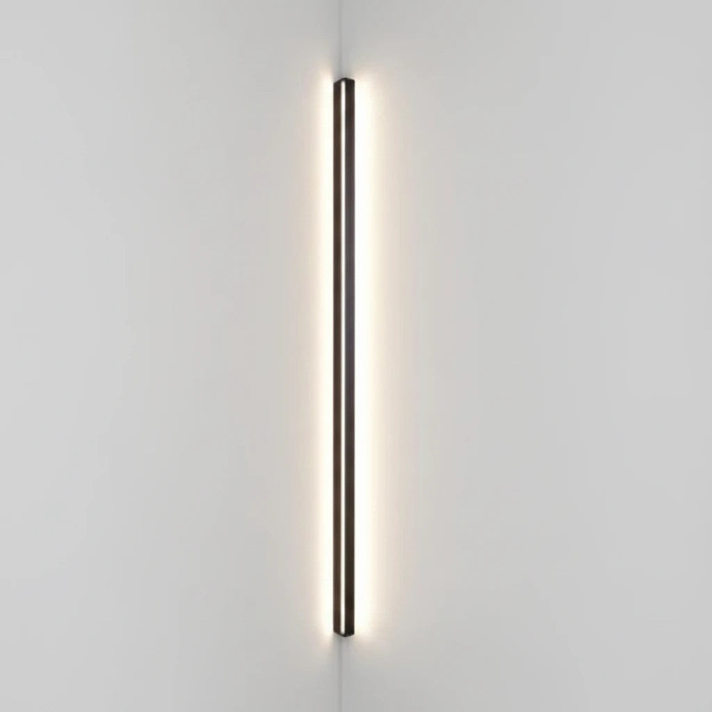 Lysverden minimalist black linear LED wall lamp mounted vertically in a corner providing warm ambient light