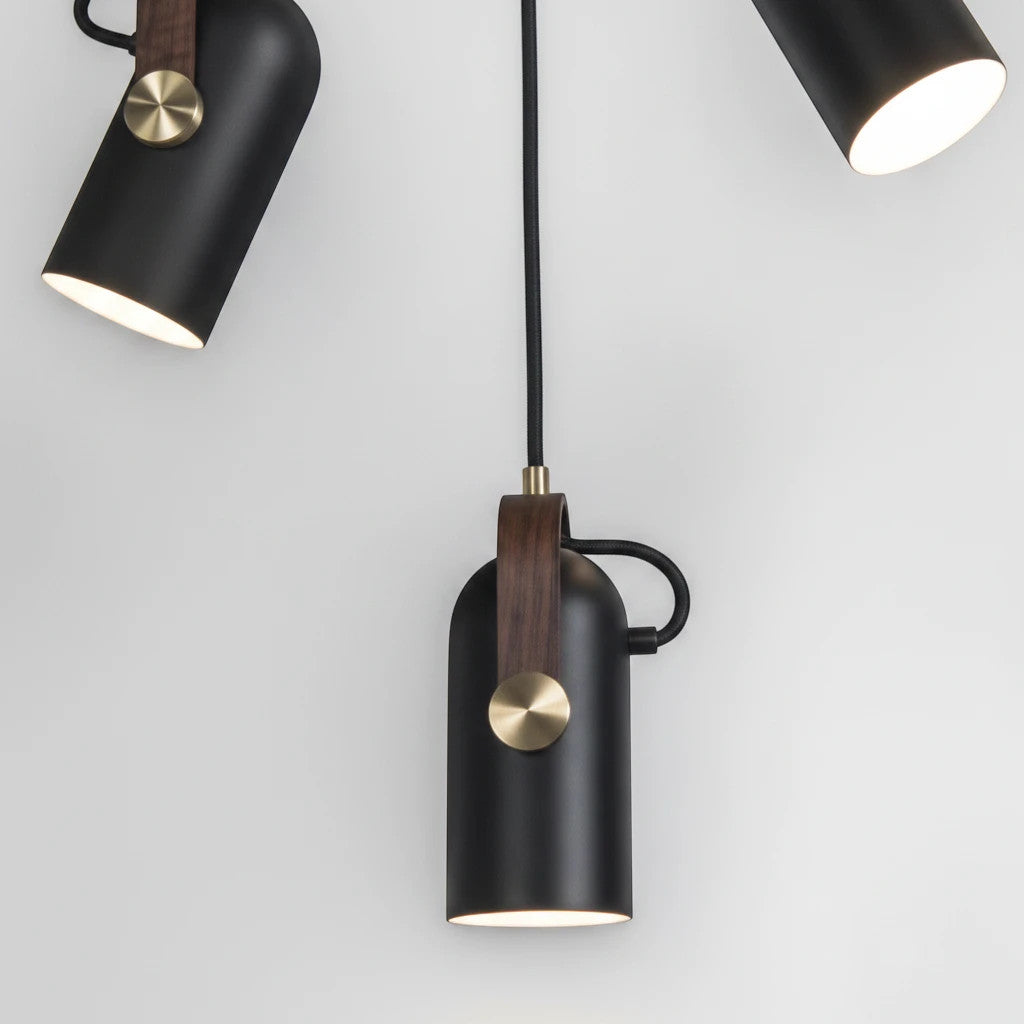 Lysverden matte black metal pendant spotlight with wood detail and brass knob, featuring adjustable LED light.