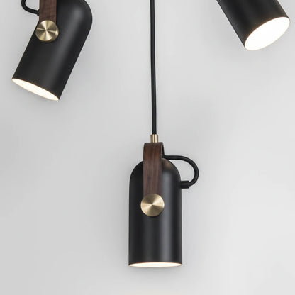 Lysverden matte black metal pendant spotlight with wood detail and brass knob, featuring adjustable LED light.