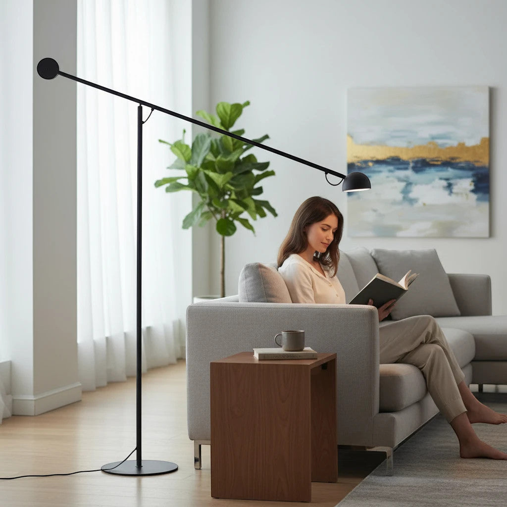 Lysverden black minimalist floor lamp with an extended arm providing focused reading light over a modern sofa.