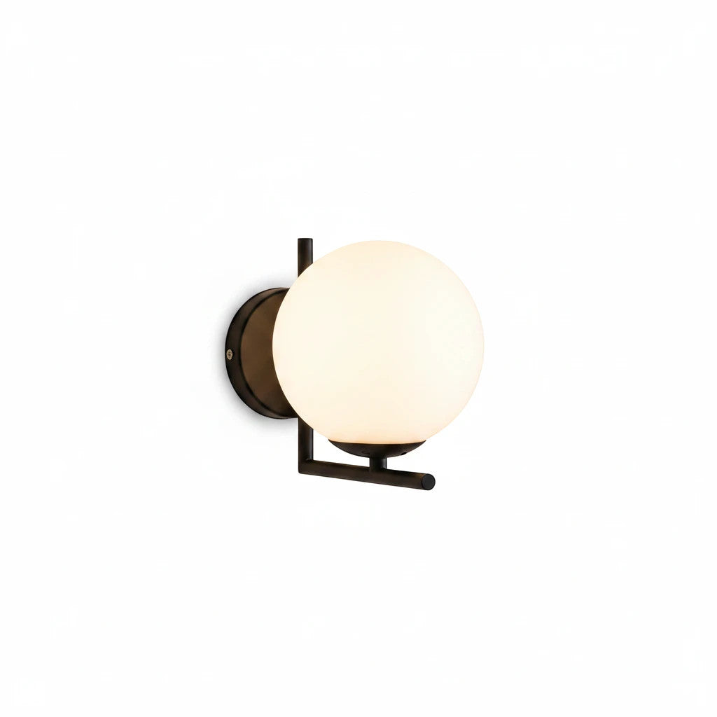 Lysverden modern wall lamp with a round opal glass globe and a minimalist black iron frame emitting soft light.
