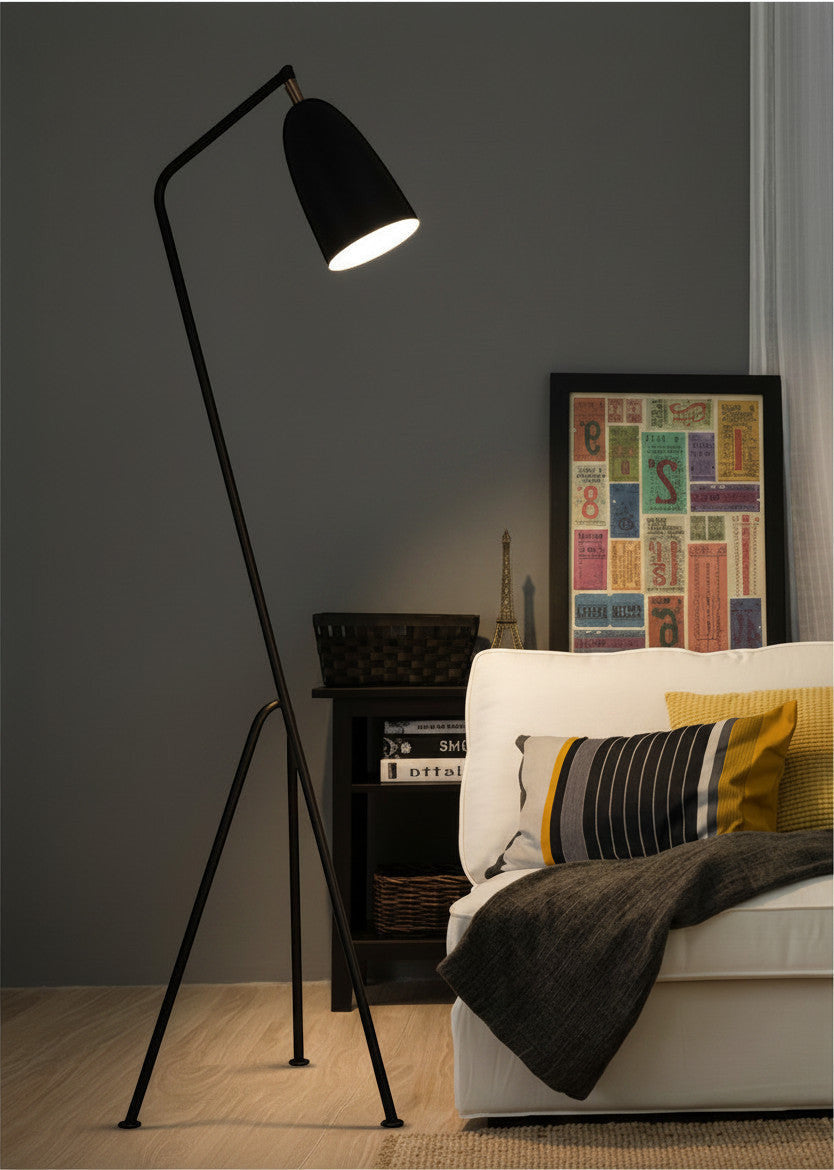 Lysverden black tripod floor lamp with an adjustable cone shade in a modern Scandinavian living room setting