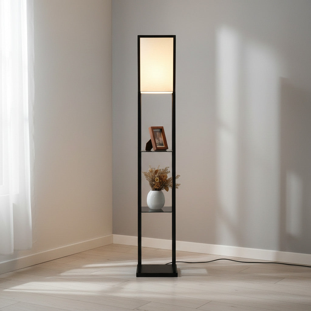 Lysverden floor lamp with black wooden frame, fabric shade, and three shelves for storage in a minimalist room.