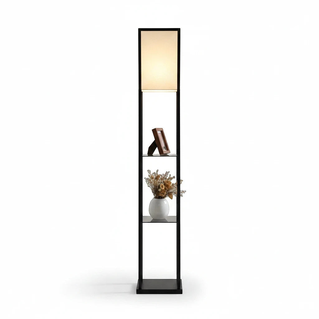 Lysverden floor lamp with black wooden frame, three storage shelves, and a soft white fabric shade emitting warm light.