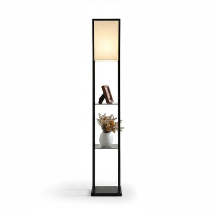 Lysverden floor lamp with black wooden frame, three storage shelves, and a soft white fabric shade emitting warm light.