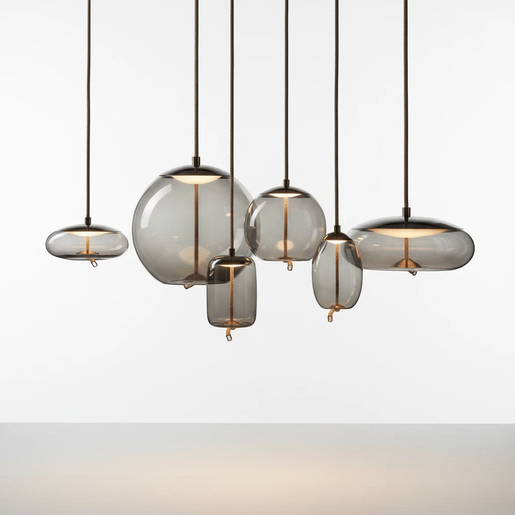 Lysverden BOBLE pendant lights in smoke-colored mouth-blown glass with organic shapes hanging at varying heights.