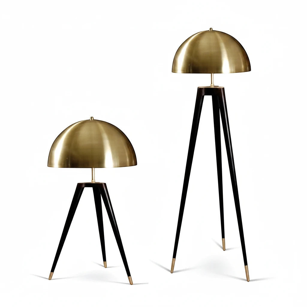 Lysverden tripod lamps with dome-shaped brass shades and sleek black legs in table and floor lamp versions.