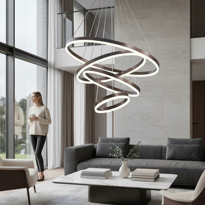 Lysverden modern LED ring chandelier with three bronze circles hanging in a luxury living room with a woman standing