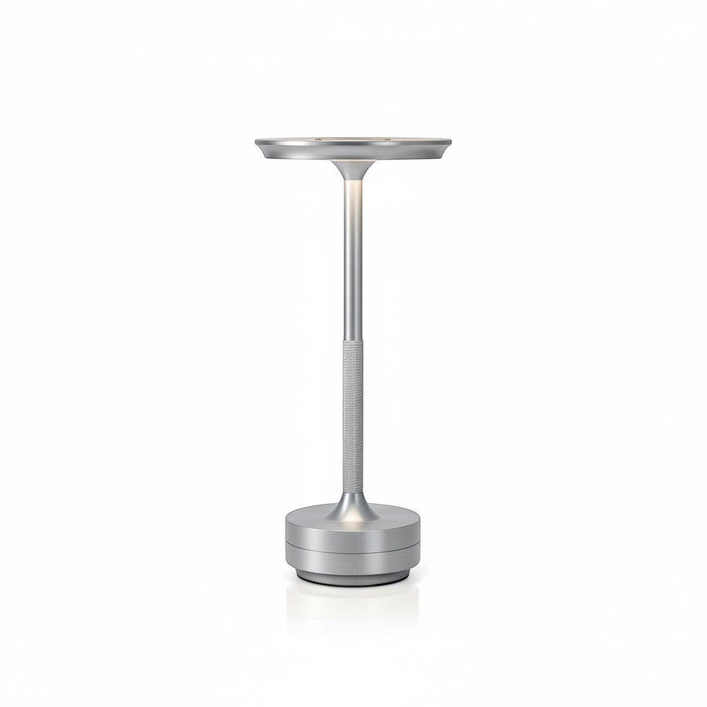 Lysverden cordless table lamp in brushed aluminum with a flat disc top and touch control. Features 3 color temperatures and dimmable light.