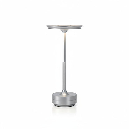 Lysverden cordless table lamp in brushed aluminum with a flat disc top and touch control. Features 3 color temperatures and dimmable light.