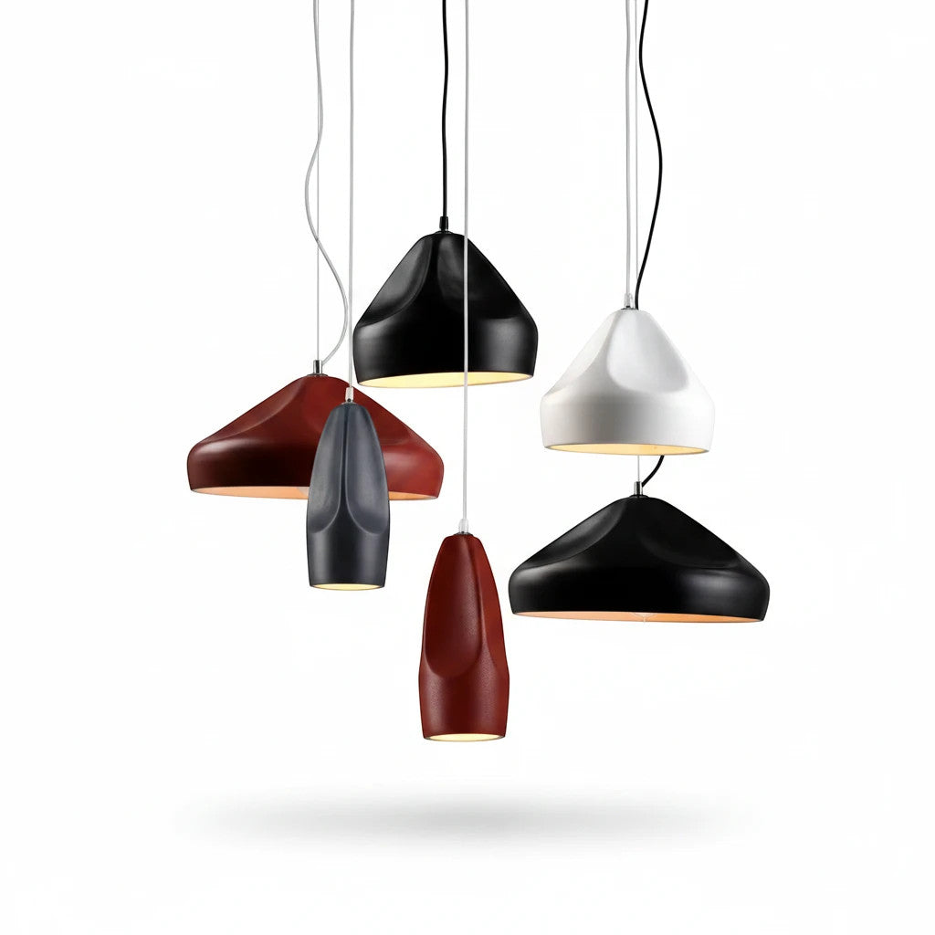 Lysverden ceramic pendant lights in various matte colors and conical shapes hanging together as a modern cluster.