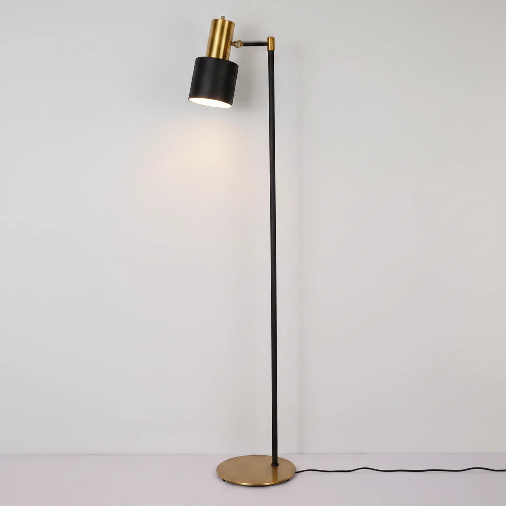 Lysverden classic floor reading lamp with a black adjustable shade, slim black stand, and a round brass base.