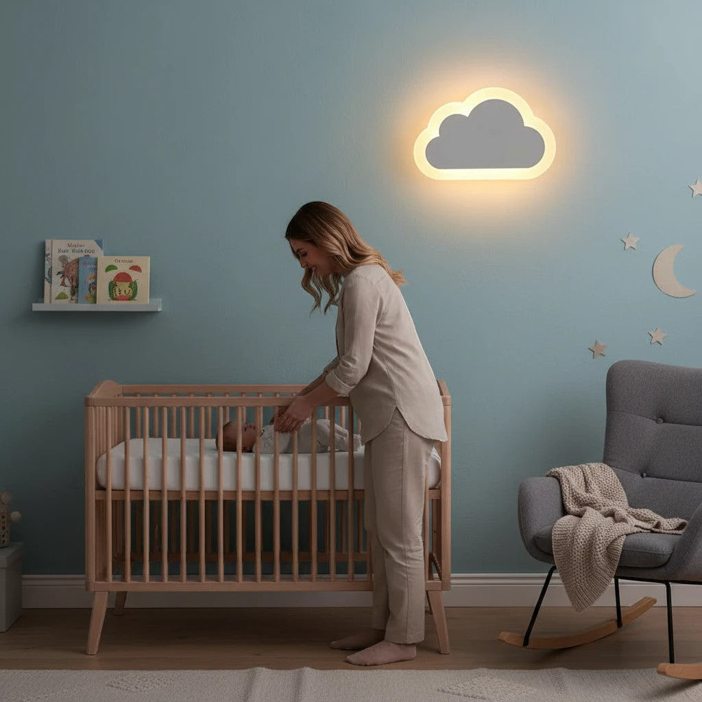 Lysverden cloud-shaped LED wall lamp glowing with warm light in a cozy nursery with a mother and baby by the crib.