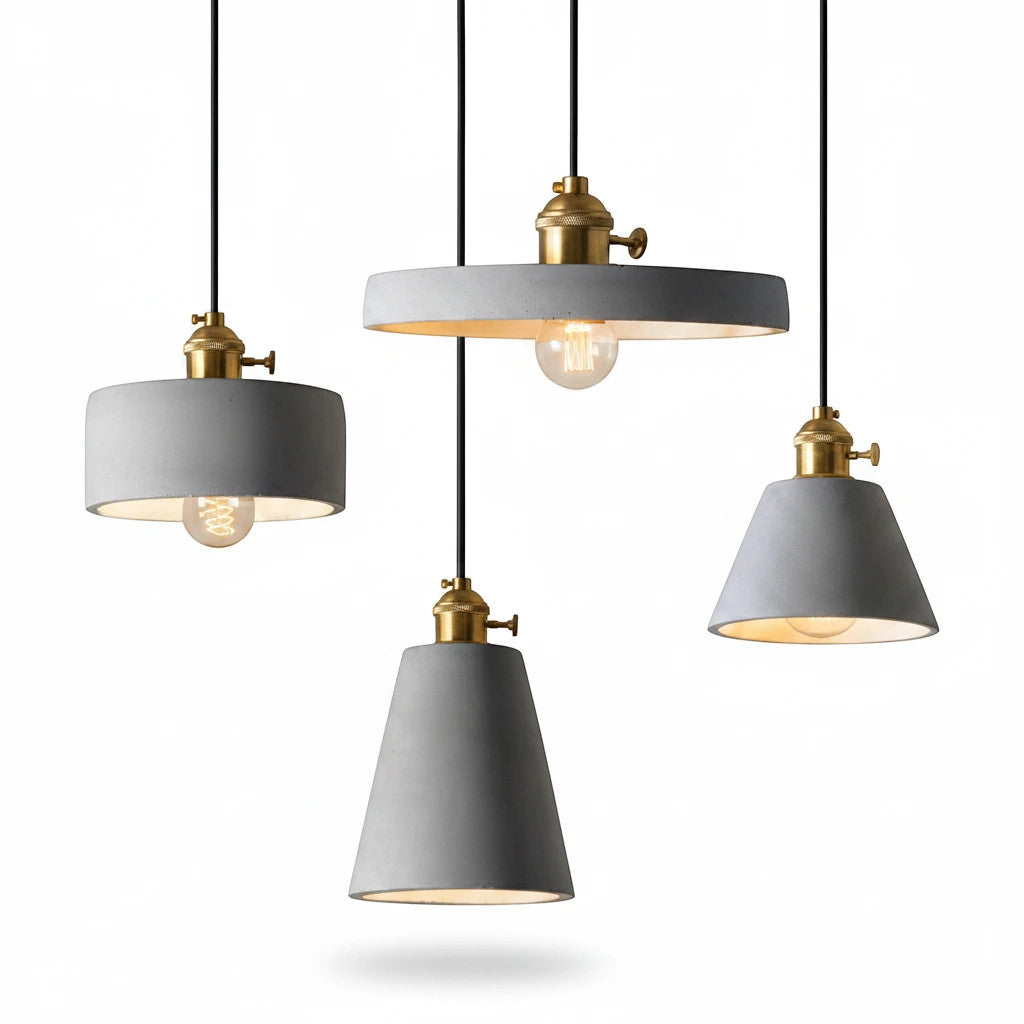 Lysverden industrial concrete pendant lights with brass details in three different shapes hanging against white.