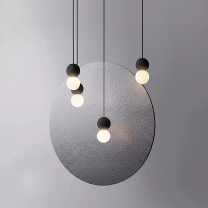 Lysverden minimalist concrete and glass globe pendant lights hanging in a cluster against a grey circular backdrop