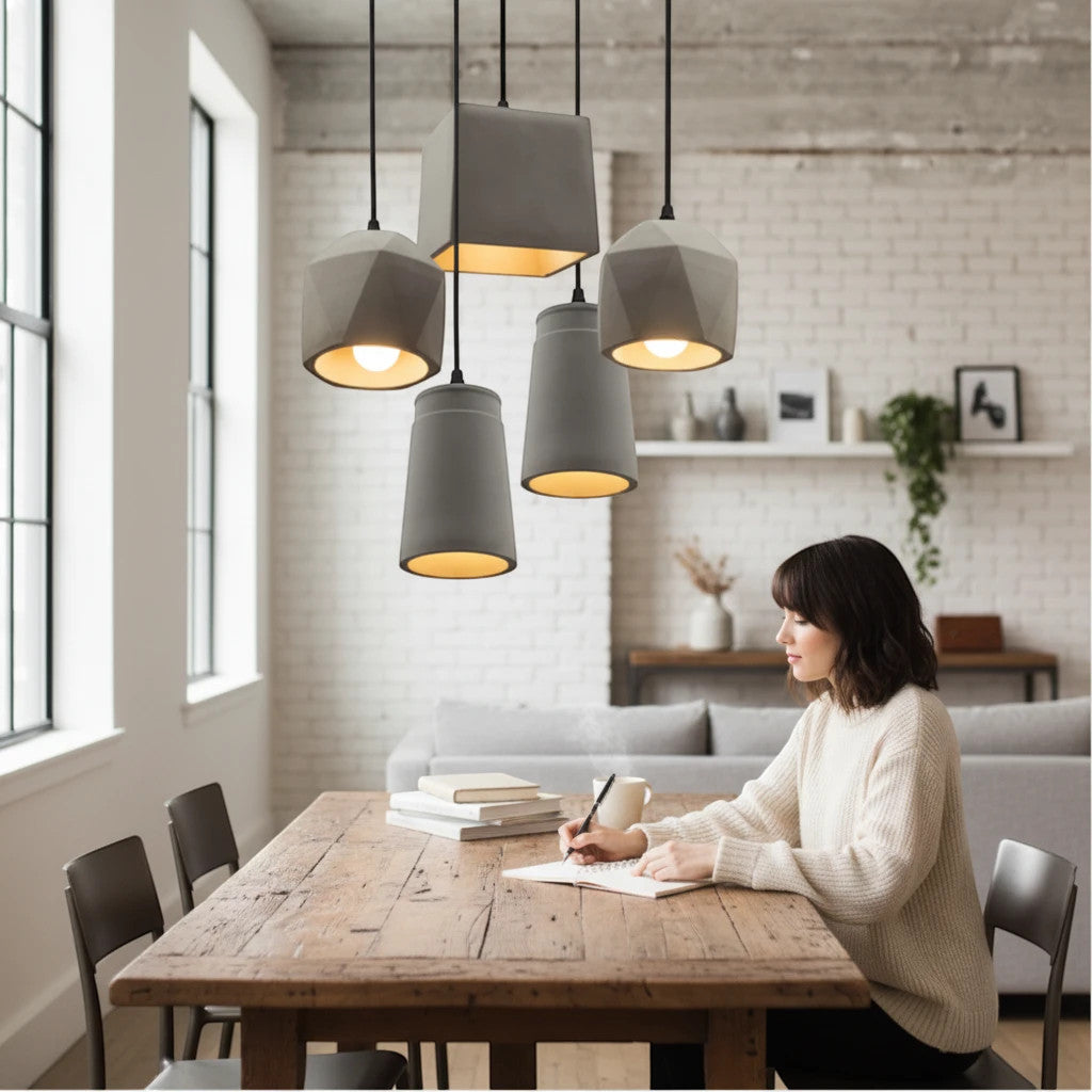 Lysverden industrial concrete pendant light cluster hanging over a rustic wooden dining table in a modern home interior.