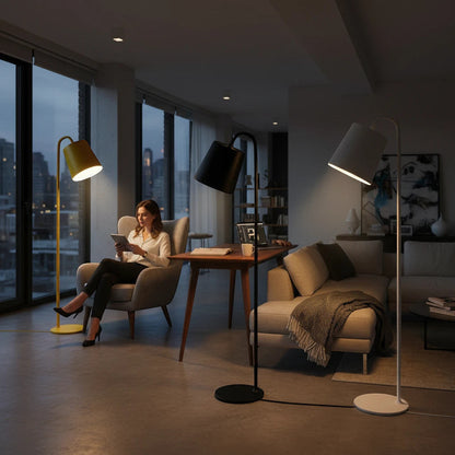 Lysverden floor lamps with cone shades in yellow, black, and white, illuminating a modern living room with a woman.