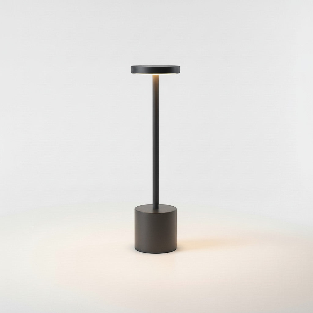 Lysverden dark grey aluminum and PC cordless disc-top table lamp with touch control and 3-level dimming.