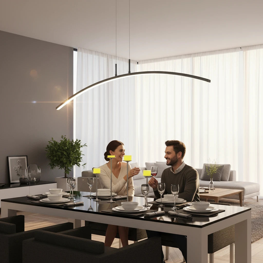 Lysverden black curved LED pendant light hanging over a modern dining table with a couple dining in a bright room.