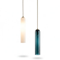 Lysverden modern cylindrical pendant lights in white and blue glass hanging from brass fixtures