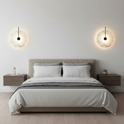 Lysverden Dolomitt minimalist wall lamps with white stone discs and warm LED glow mounted above a modern bed