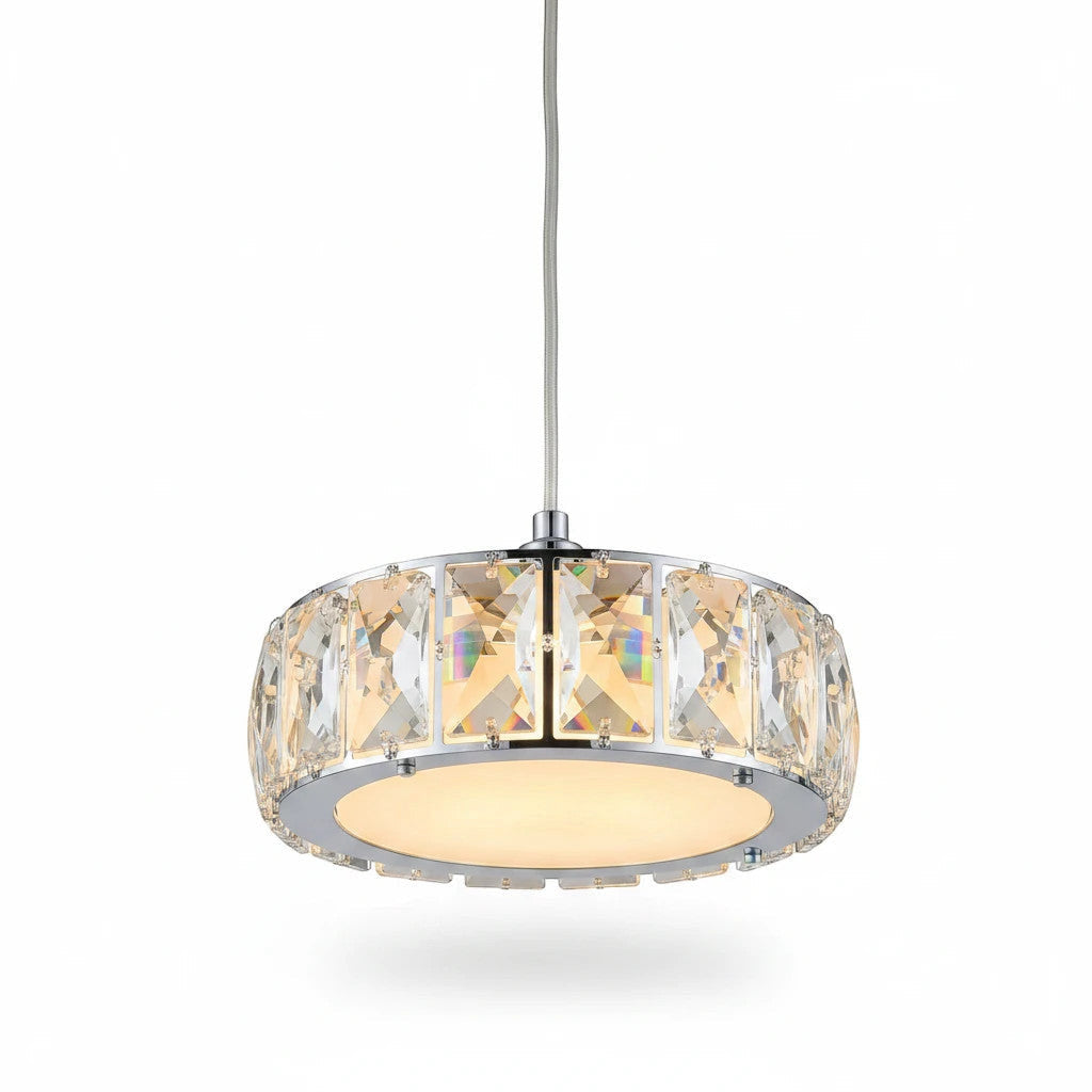Lysverden drum pendant light with a chrome frame and faceted glass panels casting a warm glow over a dining table.