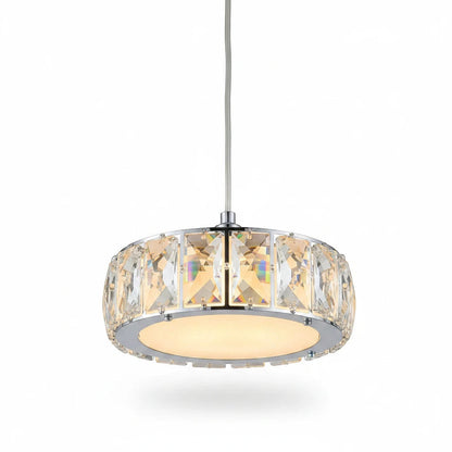 Lysverden drum pendant light with a chrome frame and faceted glass panels casting a warm glow over a dining table.