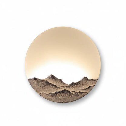 Lysverden round wall lamp with a 3D mountain relief and warm LED moon-like glow in a Japandi style design.