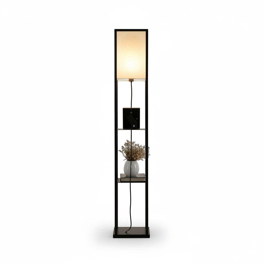 Lysverden floor lamp with black wooden frame, three storage shelves, and a soft white fabric shade emitting warm light.