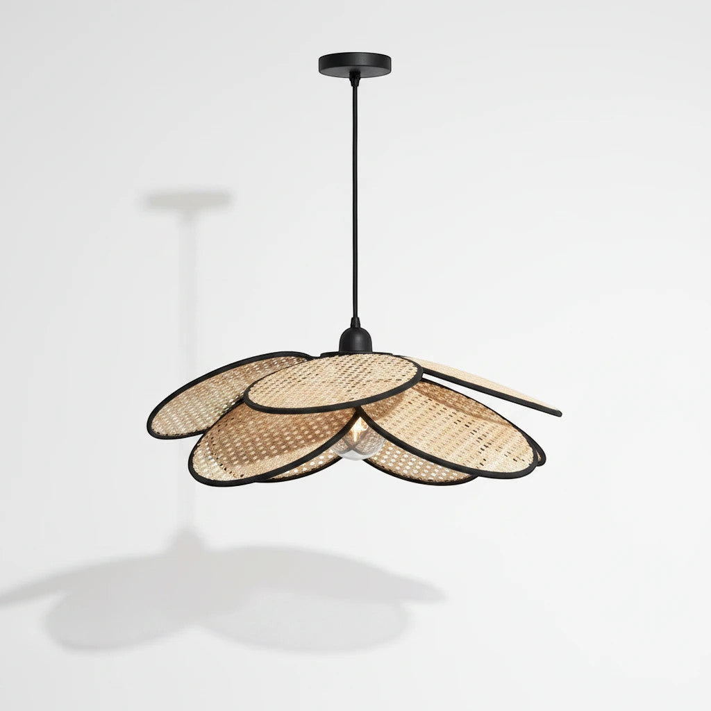 Lysverden flower-shaped rattan pendant lamp with woven natural petals and black edges for a boho interior style.